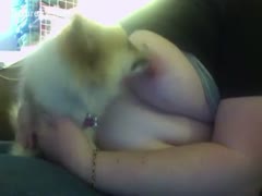 A mature beauty who allows her dog to lick her tits due to her enormous natural breasts